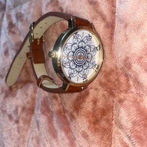 Detailed watch with gold accents Brown band